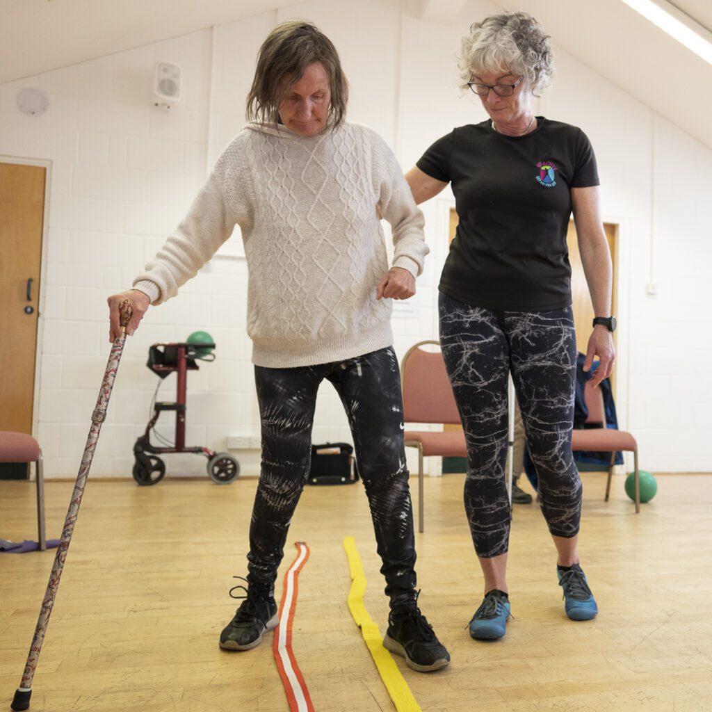 Member of East Cumbria MS Group being supported in an exercise class