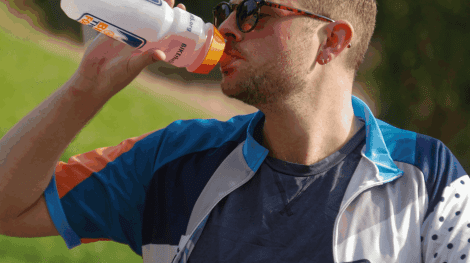 man drinking out of a bottle