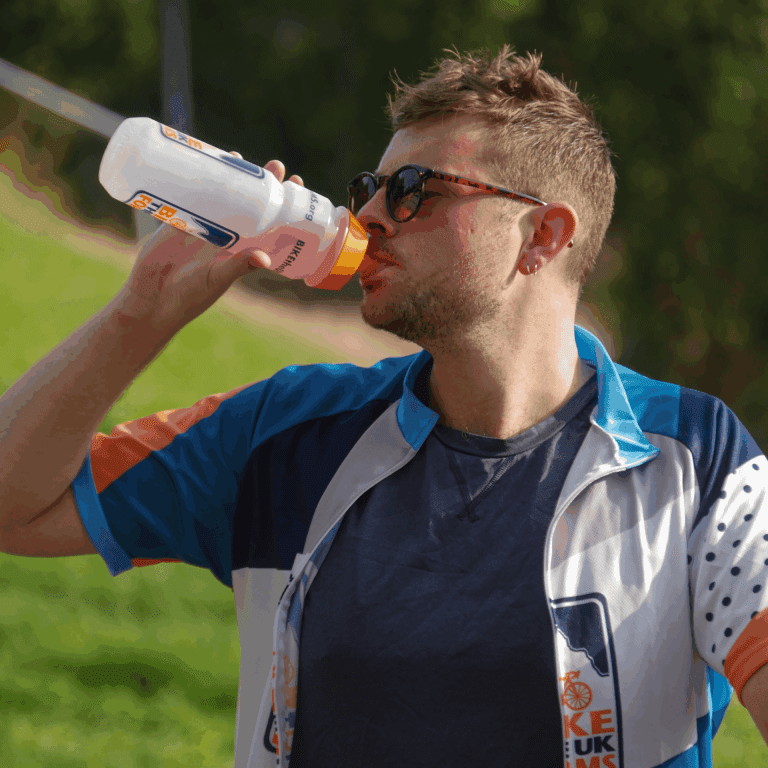 man drinking out of a bottle