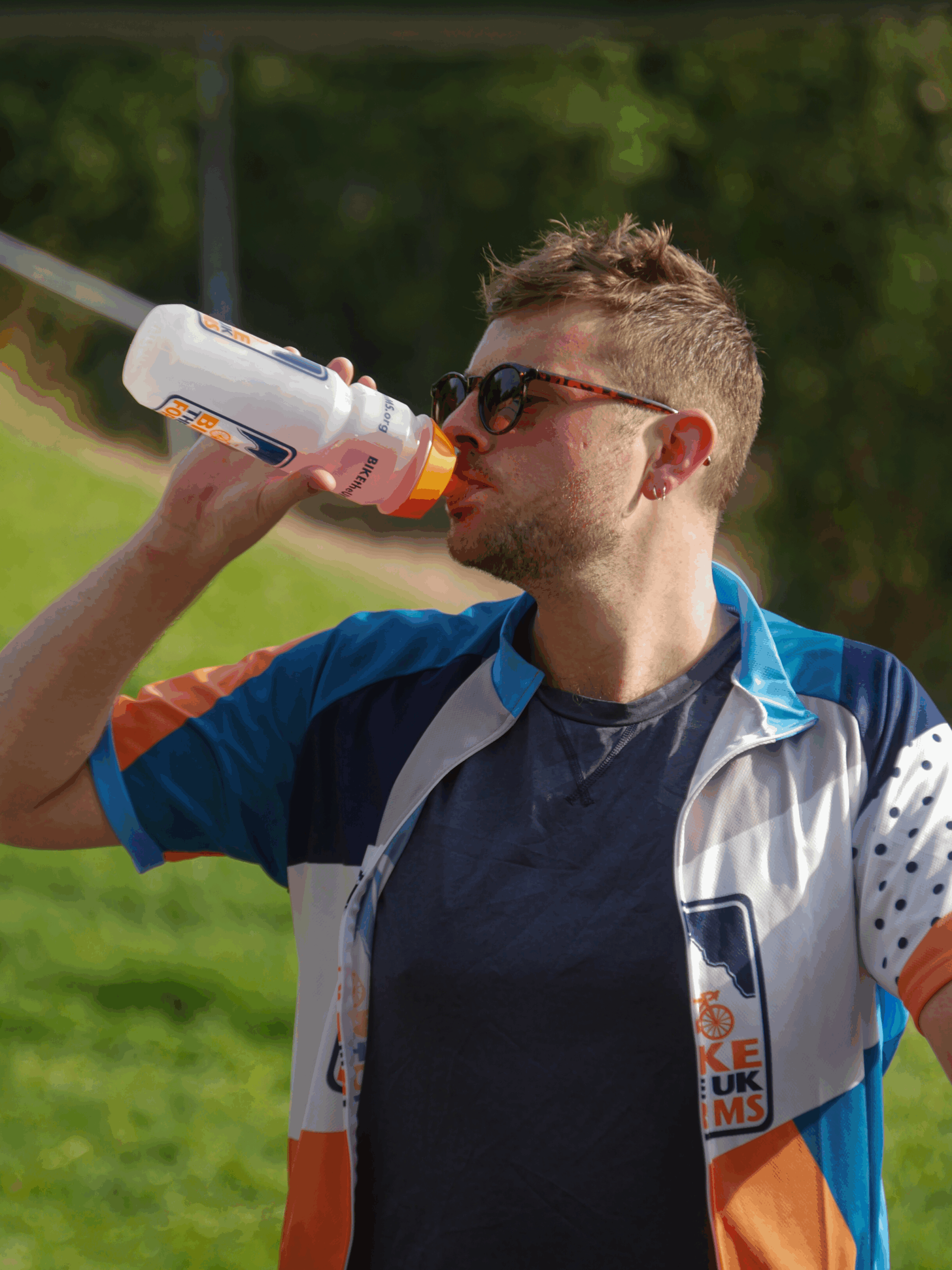 man drinking out of a bottle