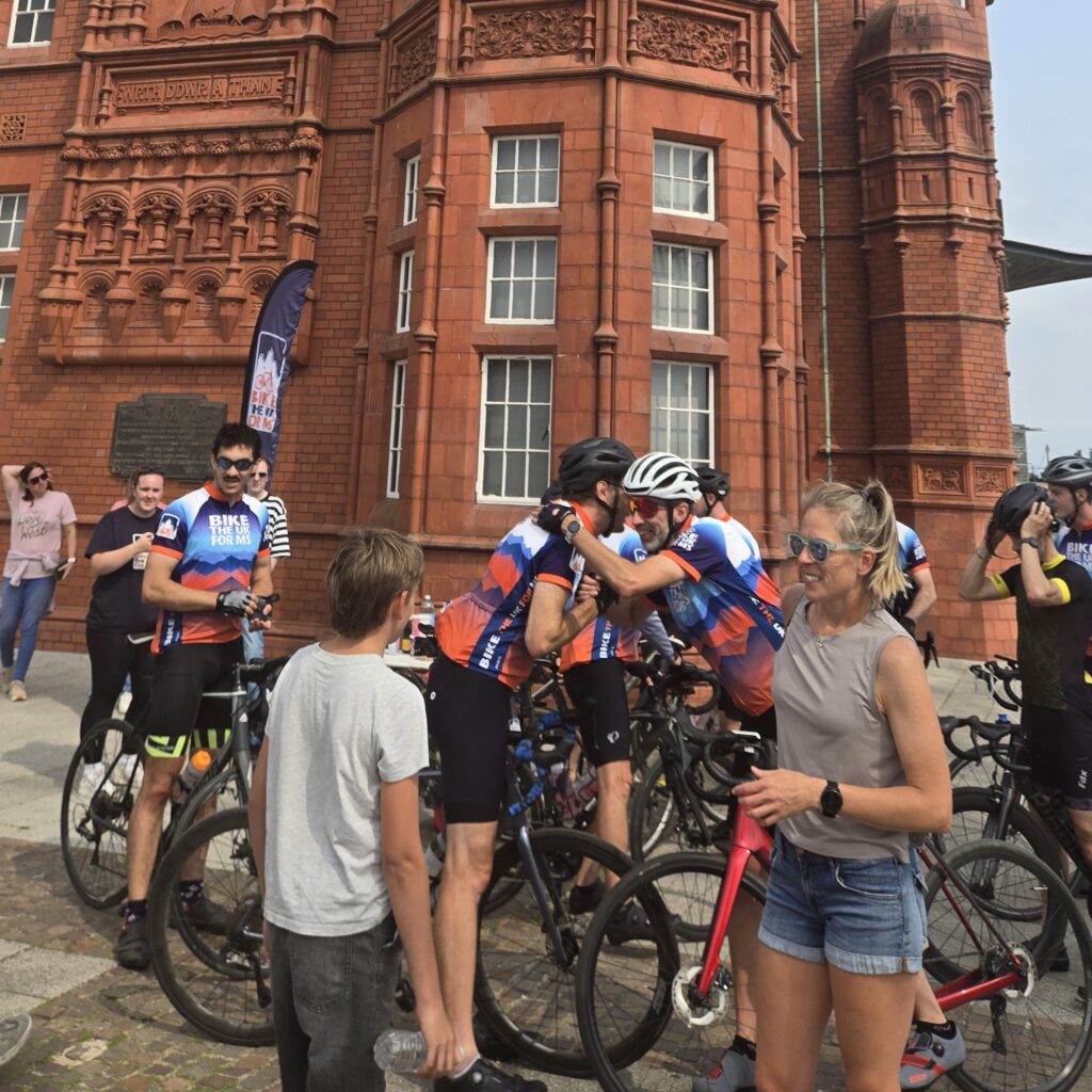 Bikers hugging after finishing their Lon Las Cymru ride 