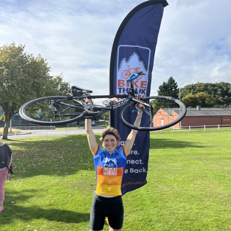 NC500 rider lifting bike in celebration