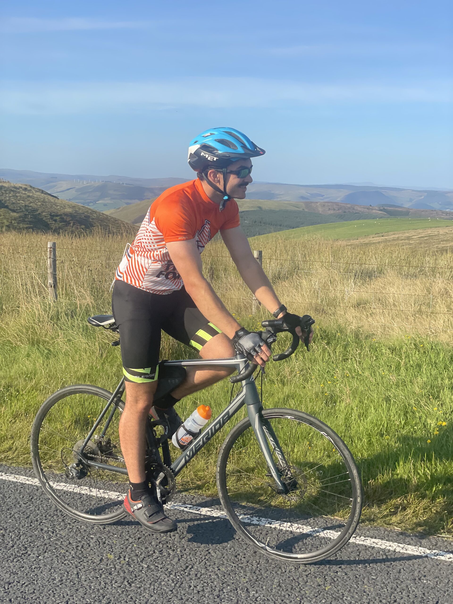 Rider at peak of Lon Las Cymru hill